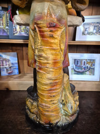 African boy statue carrying fruit