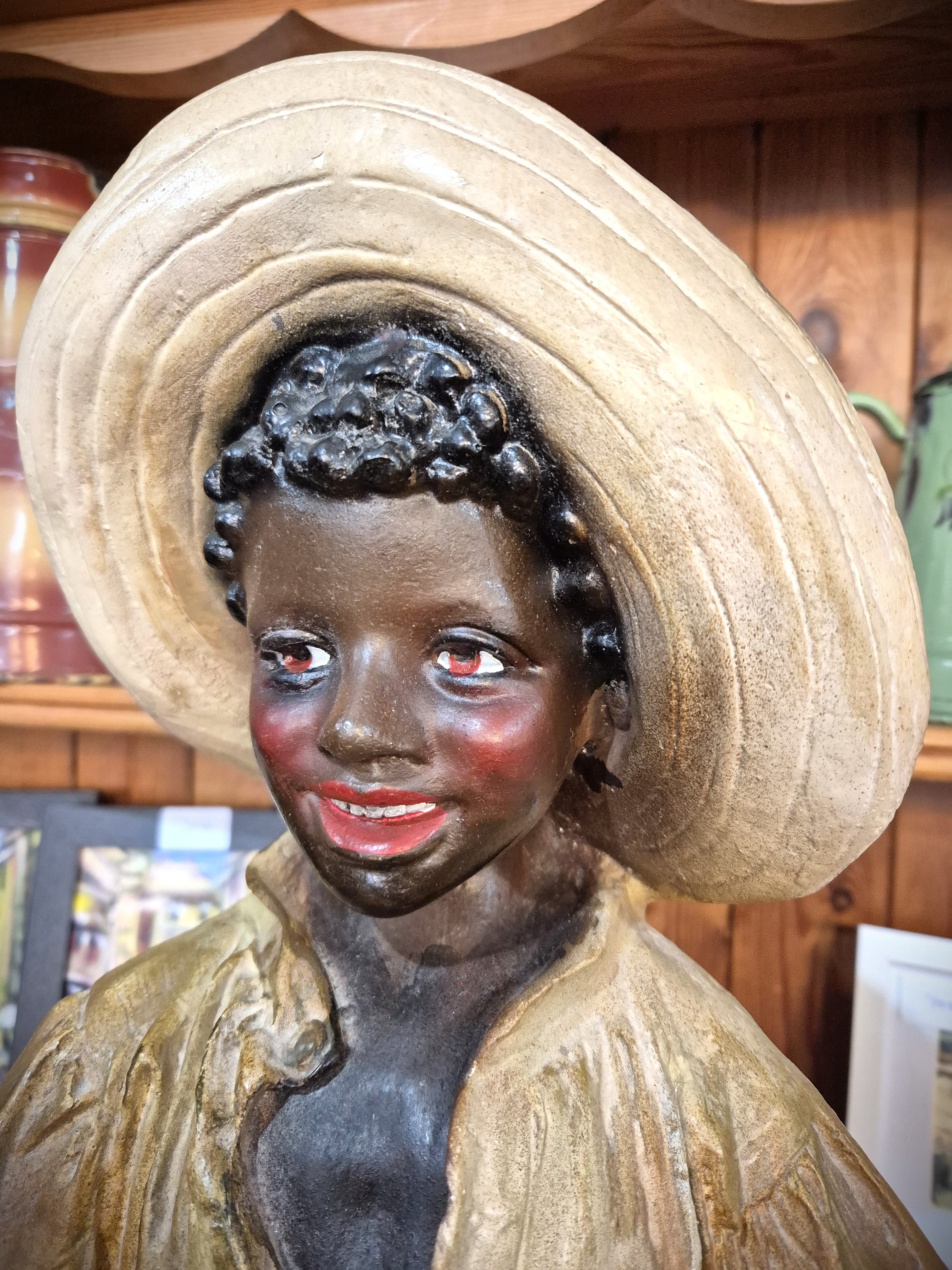 African boy statue carrying fruit