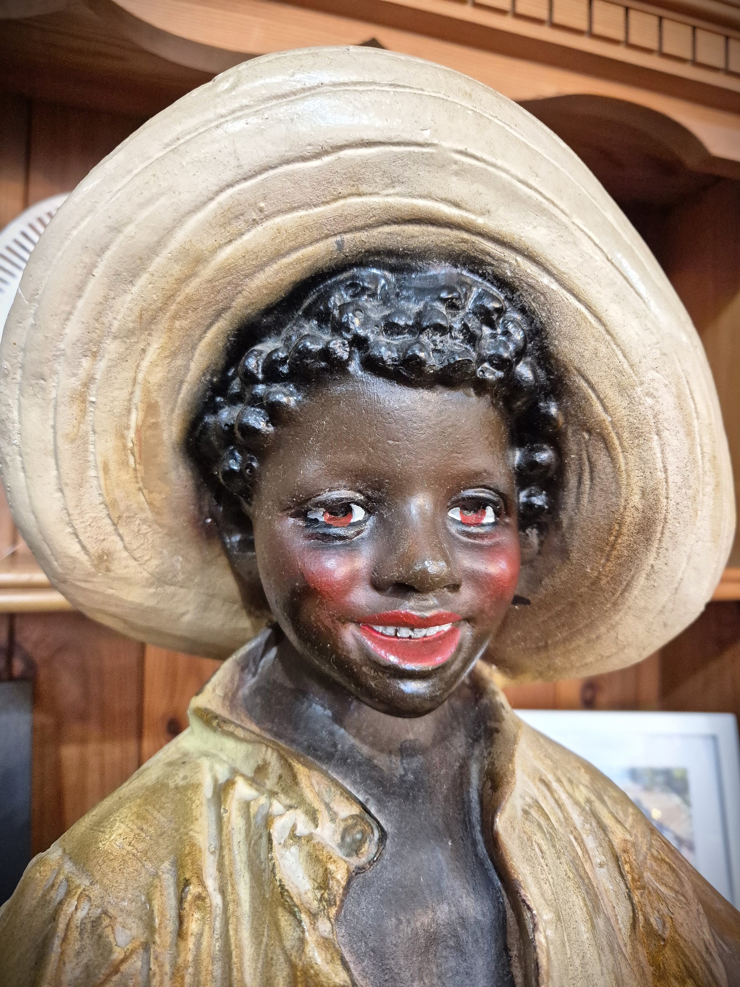 African boy statue carrying fruit