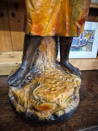 African boy statue carrying fruit