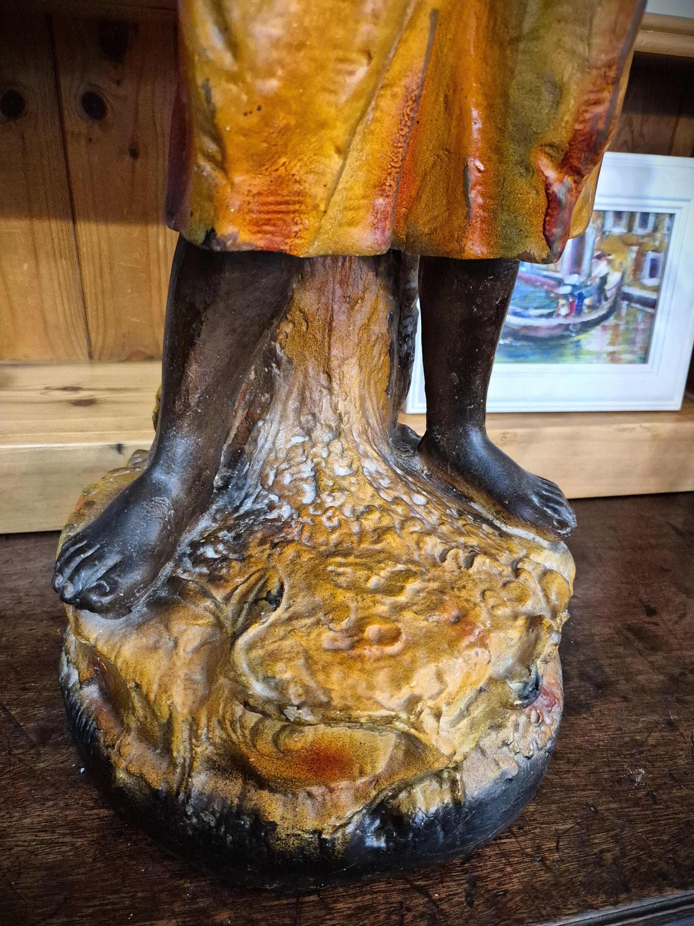 African boy statue carrying fruit
