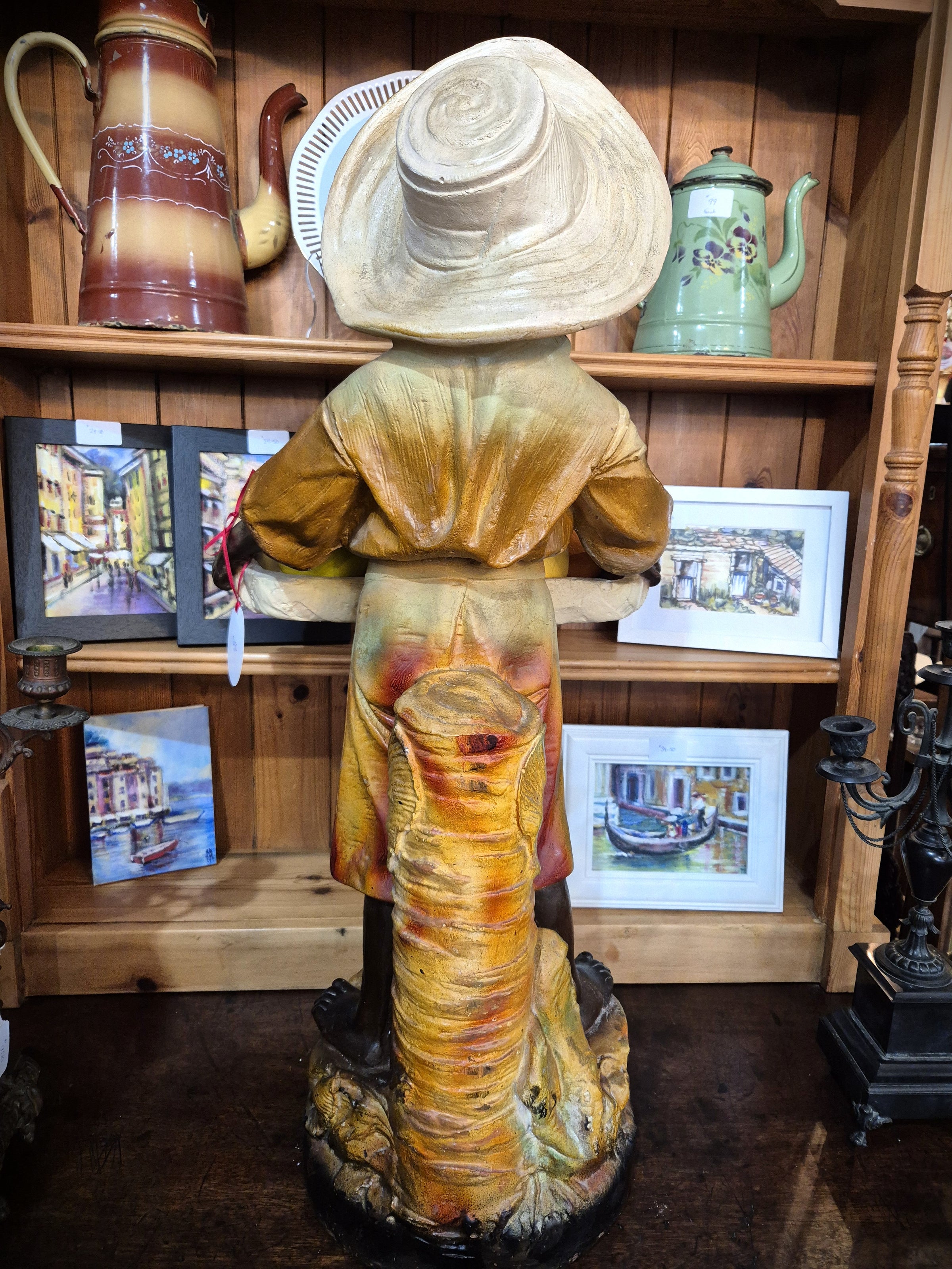 African boy statue carrying fruit