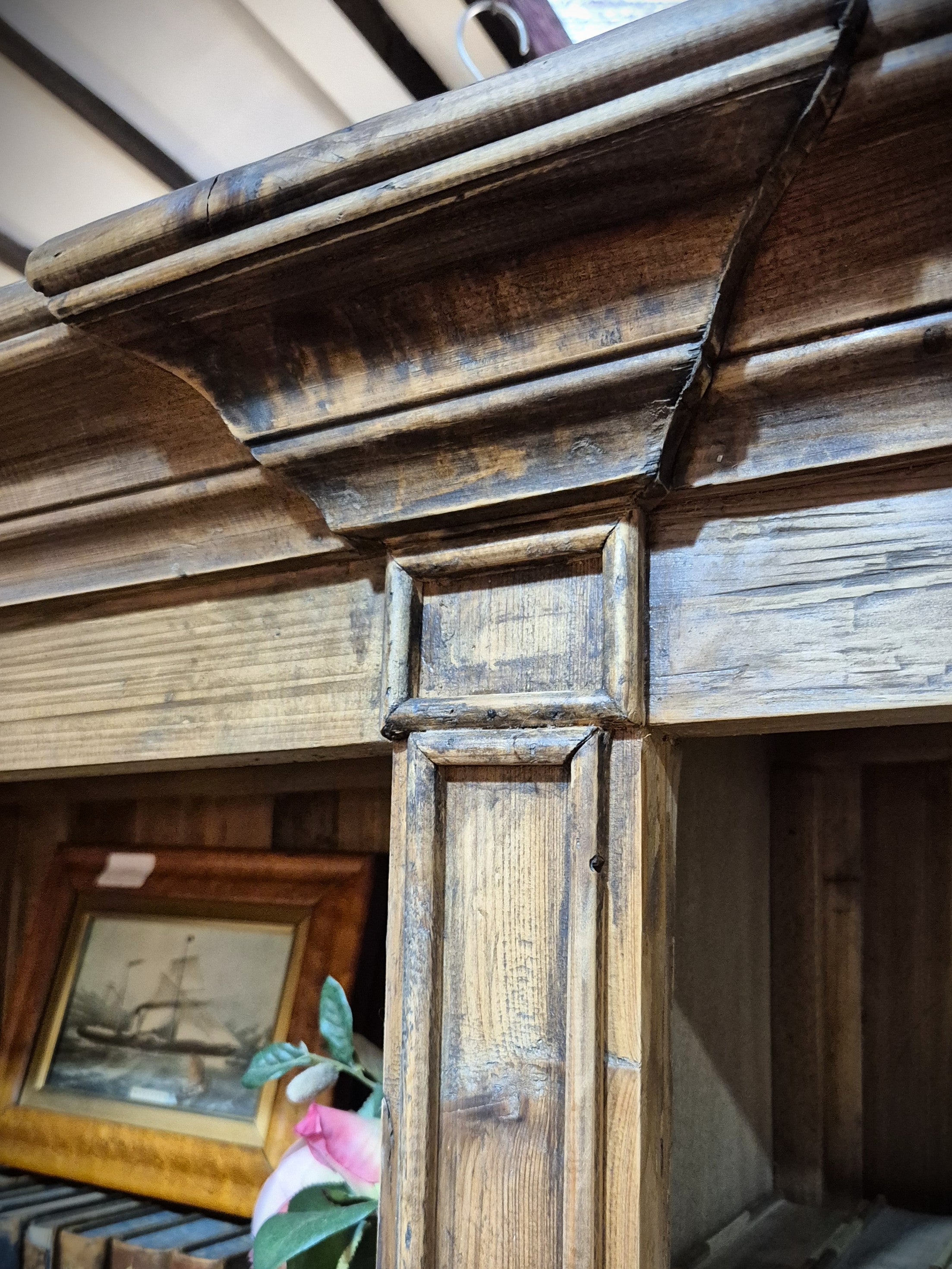 Close up of the top of reproduction baltic pine bookcase.