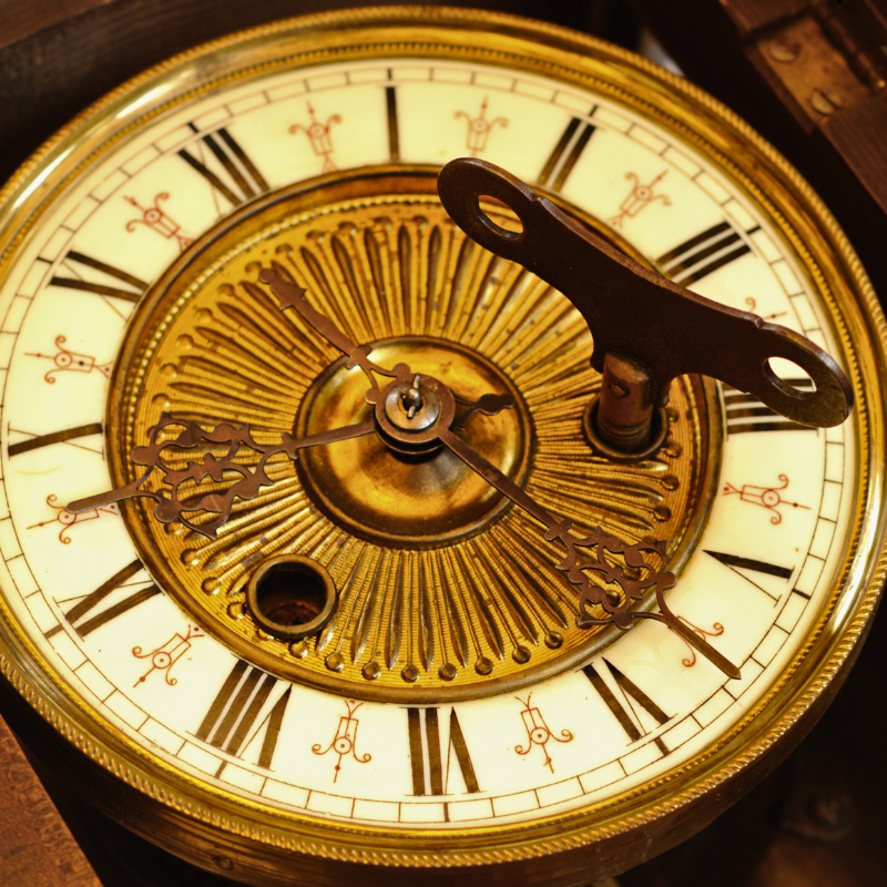 Clocks, barometers and tools.  Photo of a clock face with key.