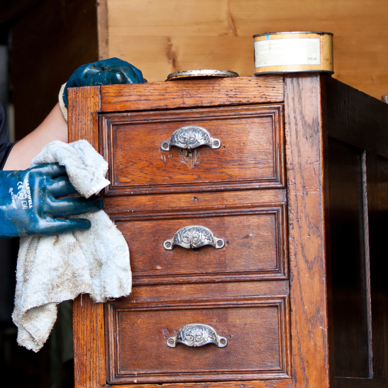 Photo of a person waxing furniture
