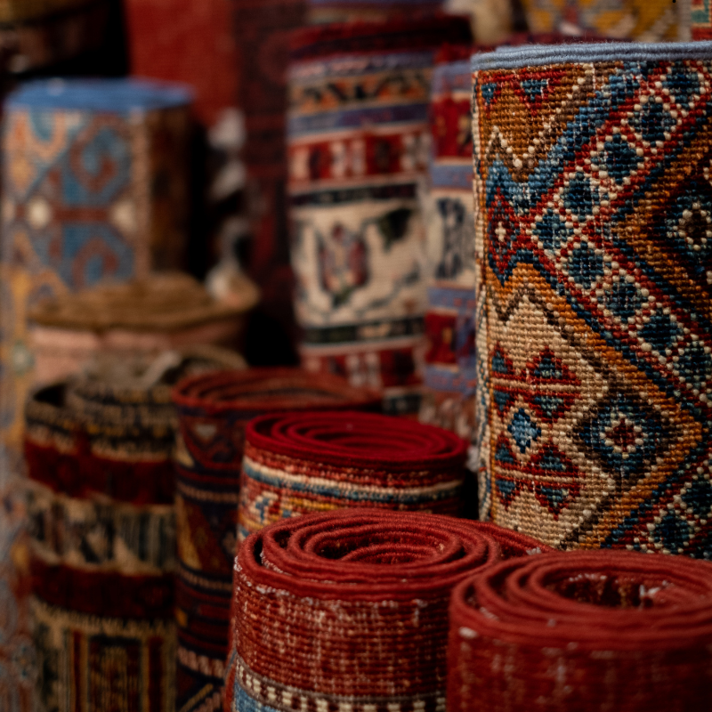 Textiles & Rugs.  A photo of rolled up rugs. 