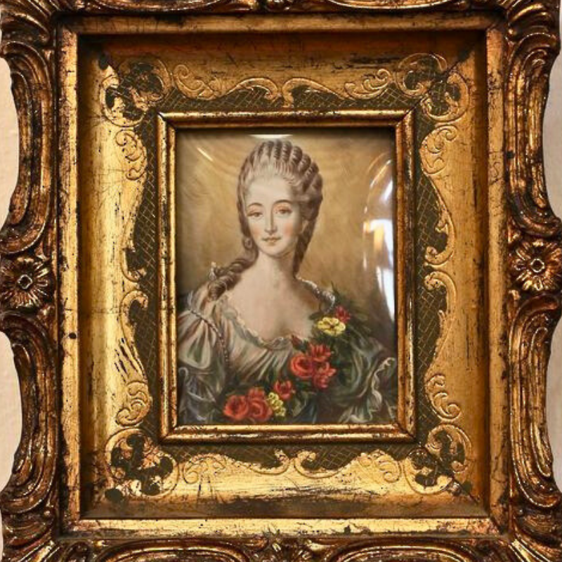 Art.  Photo of a ladies portrait in a gilt frame