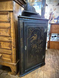 Antique Chinese black Corner Cabinet featuring painted birds and floral designs in gold. 