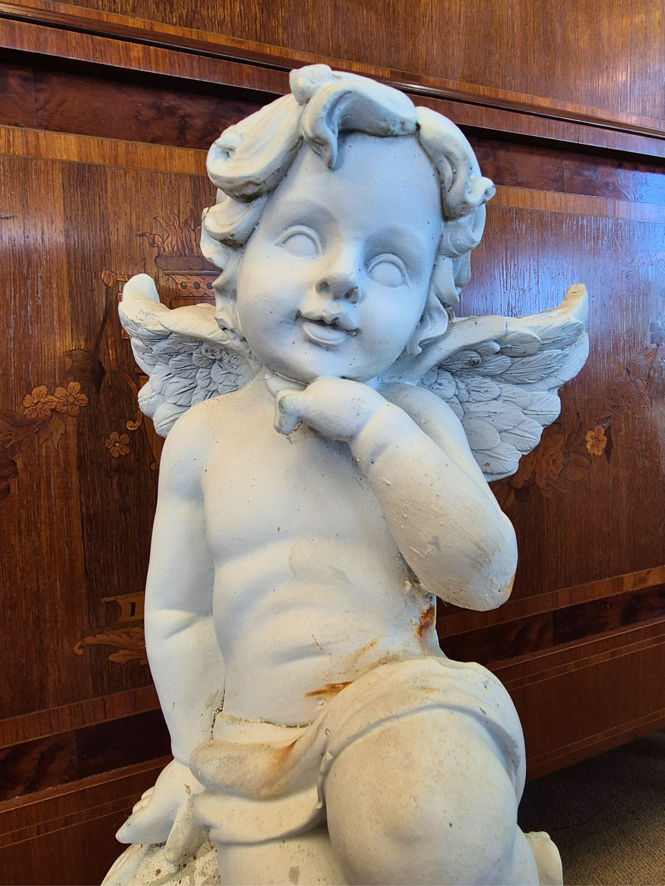 Vintage Cherub Garden Statue close up of the face.