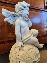 Statue of a winged figure on a spherical base 