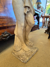 Stone sculpture of a female garden statue, close up of the legs