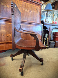 American antique oak swivel office chair side view.