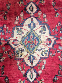 Close-up of a red Persian rug with intricate designs