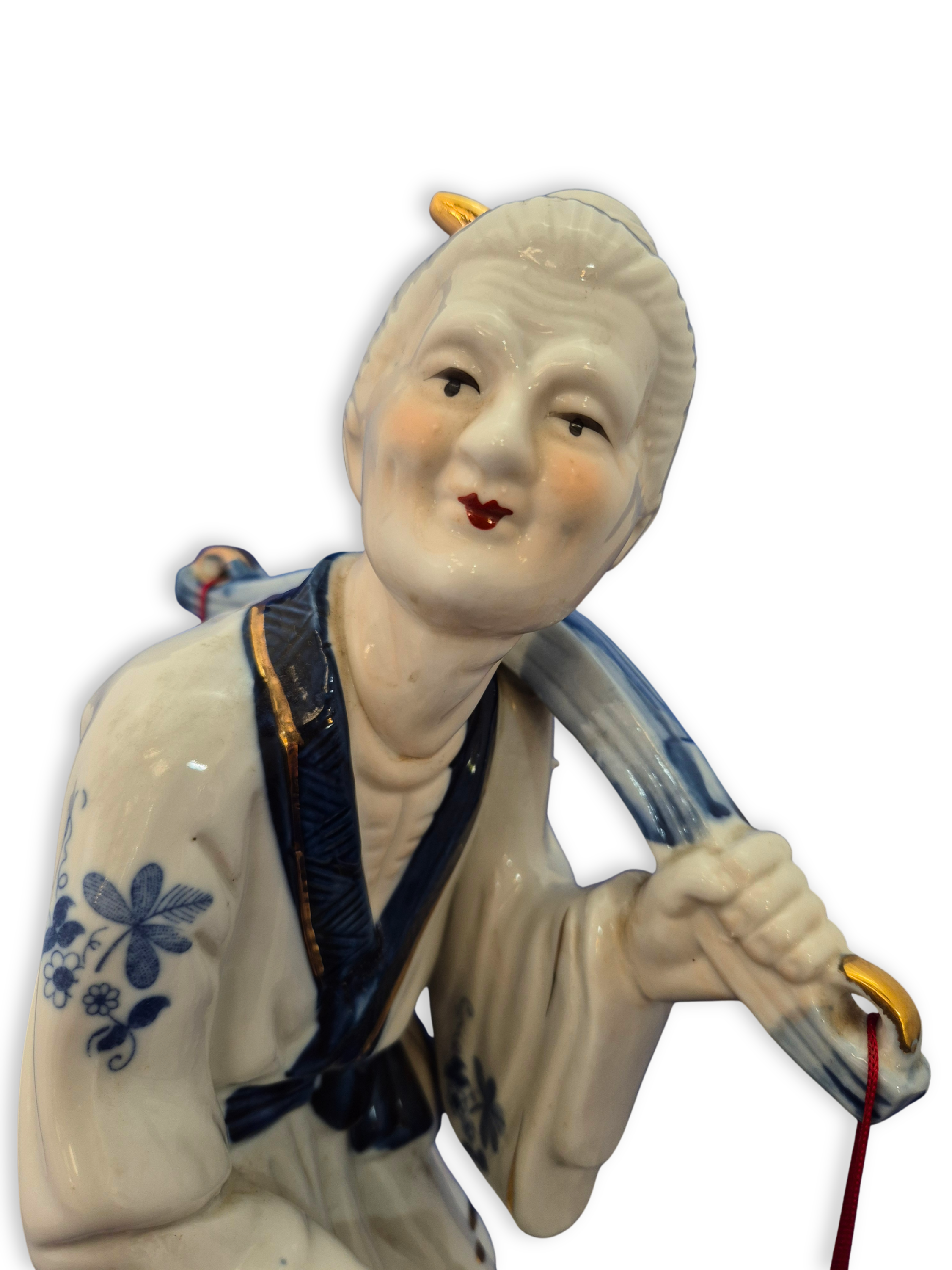Vintage chinese fisher woman figuirine close up.