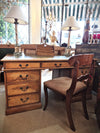 Vintage Oak Partners Desk displayed with two lamps and a chair.