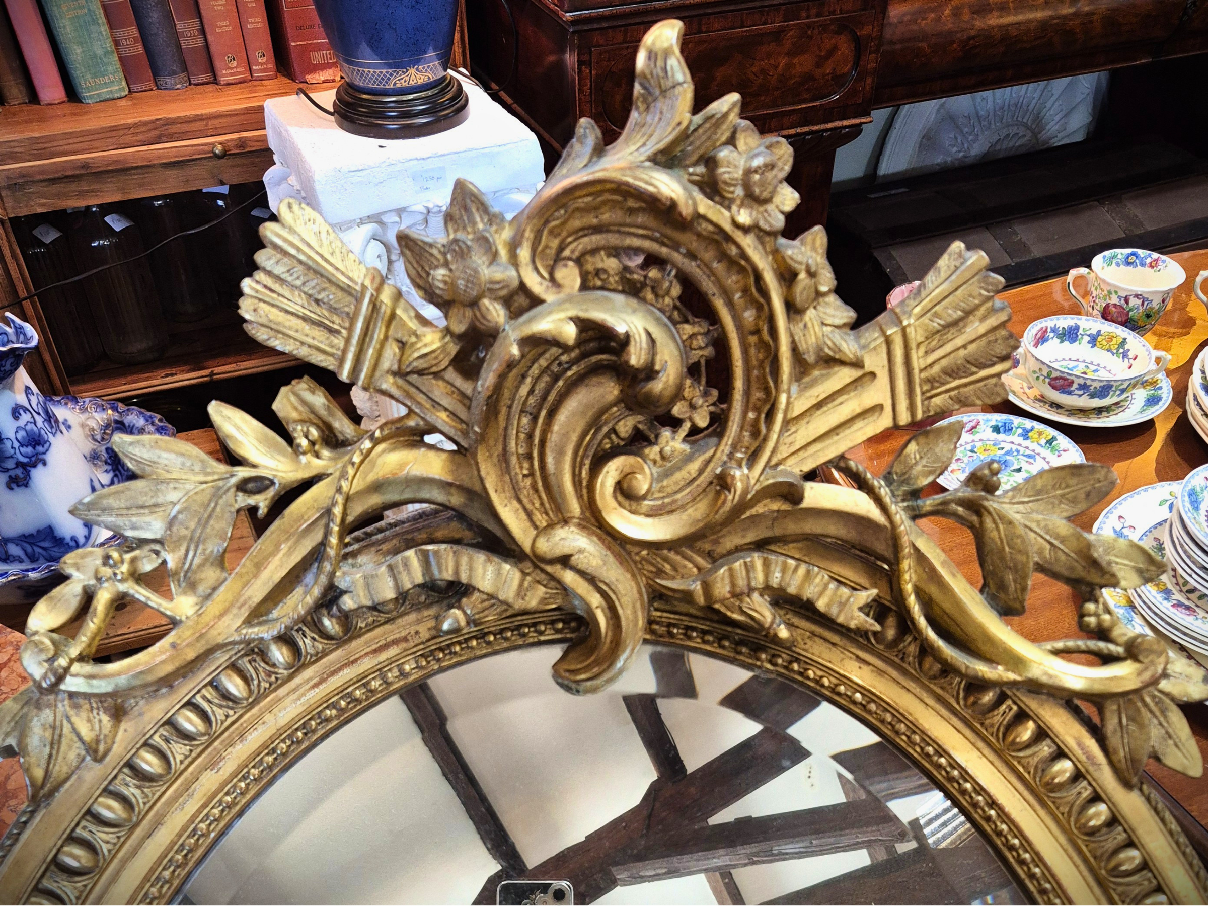 Decorative gold mirror with intricate designs close up.